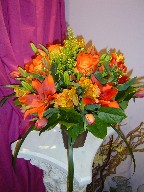 Roses, coffee beans, solidago, alstroemeria, lillies, tulips, and monkey grass
