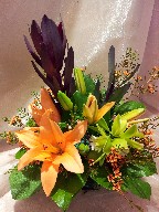 Asiatic lillies, leucadendron, cymbidium orchid, and waxflowers