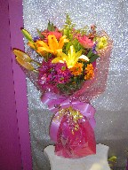 Gerbera, alstromeria, solidago, daisies, iris, lillies, and waxflowers