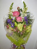 Roses, snapdragon, solidago, iris, coffee beans, alstroemeria, and lillies