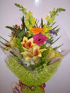 Shocking lillies, snapdragon, gerbera, lisianthus, solidago, alstroemeria, and coffee beans