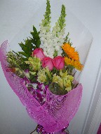 Roses, snapdragon, gerbera, dendrobium orchids, alstroemeria, waxflowers, and ruscus