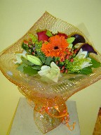 Calla lillies, lillies, gerbera, roses, solidago, and hypericum