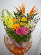 Bird of paradise, snapdragon, gerbera, sunflowers, alstroemeria, and coffee beans