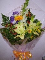 Lillies, snapdragon, lisianthus, gerbera, coffee beans, and helenium