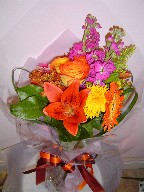 Lillies, gerbera, roses, protea, solidago, coffee beans, and stock