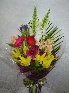 Roses, lillies, iris, gerbera, alstroemeria, snapdragon, daisies, solidago, and palm