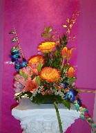 Blue dendrobium orchids, circle roses, tulips, asiatic lillies, alstroemeria, wax flowers, and statice