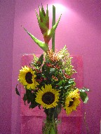Sunflowers, heliconia, coffee beans, protea, and solidago