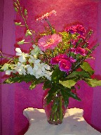 Philodendron, orchids, solidago, and mini carnations