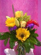 Sunflowers, ginger, solidago, roses, lillies, and statice