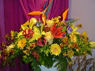 Bird of paradise, roses, lisianthus, lillies, solidago, daisies, helenium, and coffee beans
