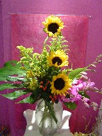 Sunflowers, coffee beans, solidago, orchids, alstroemeria, and monstera
