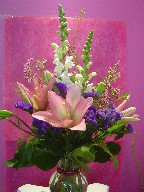 Snapdragon, statice, waxflowers, and lillies
