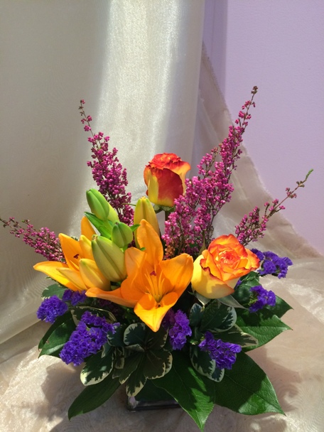 Roses, lilies, statice, heather, and variegated pitt