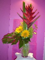 Heliconia, sunflowers, monstera, and solidago