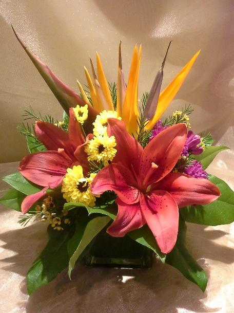 Bird of paradise, asiatic lilies, daisies, and waxflowers