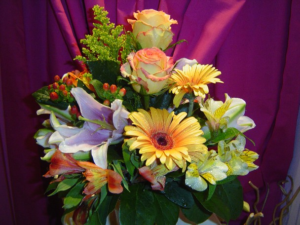 Alstroemeria, lilies, roses, gerbera, hypericum, and solidago