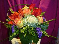 Roses, cabbage, fresia, solidago, statice, and lillies