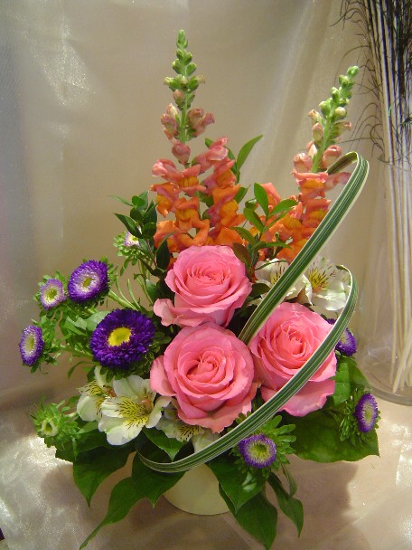 Roses, snapdragon, aster, alstroemeria, and monkey grass