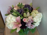 Hydreangea, roses, commercial mums, asiatic lillies, dahlia, calla lillies, alstroemeria, monkey grass, and variegated pitt