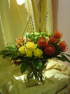 Protea, roses, alstroemeria, pompoms, and steel grass