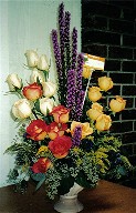 Yellow, two-tone and white roses, solidago, liatris and seeded eucalypthus