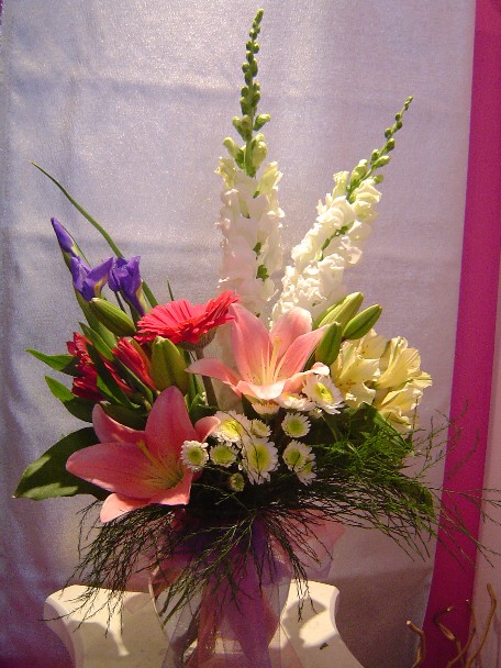 Lilies, iris, snapdragon, gerbera, alstroemeria, and daisies