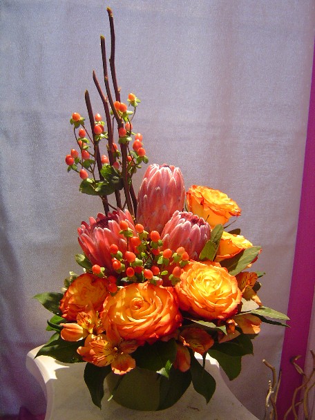 Roses, protea, alstroemeria, and hypericum