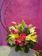 Pussy willow, tulips, lillies, alstroemeria, casino blue, roses, and waxflowers