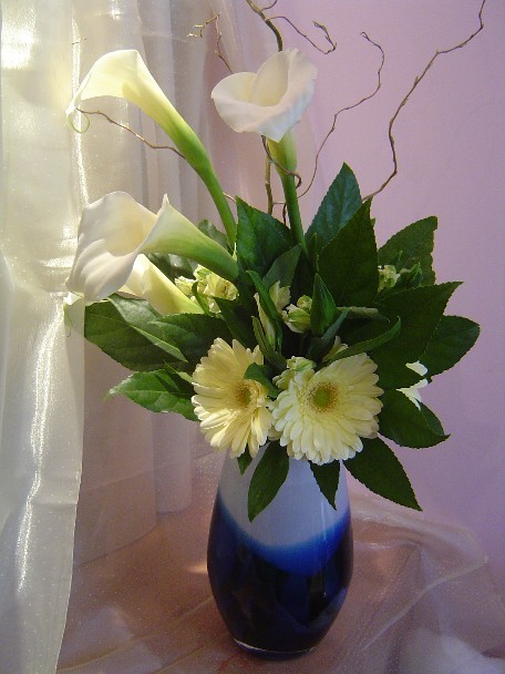 Calla lilies, gerbera, alstroemeria, curly willow, and fatsia japonica