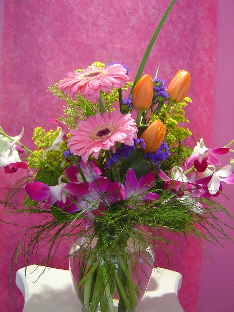 Gerbera, dendrobium orchids, tulips, solidago, statice and monkey grass