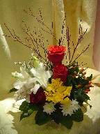 Roses, lillies, alstroemeria, daisies, hypericum, and branch