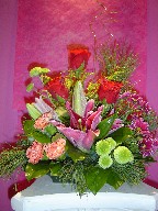 Stargazer, roses, solidago, daisies, pompom, and carnations
