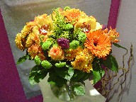Gerbera, tulips, cymbidium orchids, solidago, roses, alstroemeria, pompoms, and daisies