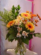 Gerbera, alstroemeria, solidago, daisies, and ruscus