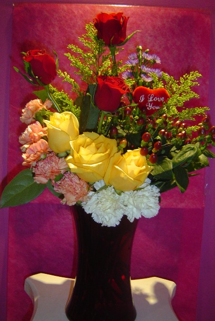 Roses, solidago, hypericum, monte casino blue, and carnations