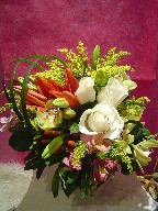 Roses, lillies, orchids, coffee beans, alstroemeria, solidago, and monkey grass