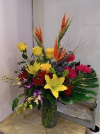 Bird of paradise, roses, gerbera, dendrobium orchids, asiatic lillies, thistle, alstroemeria, and monstera