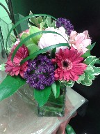 Alium, peony, gerbera, alstroemeria, monkey grass, and variegated pitt