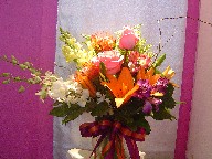 Protea, snapdragon, solidago, roses, lillies, dendrobium orchids, and alstroemeria