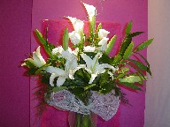 Casablanca, calla lillies, vendela roses, berries, and freesia