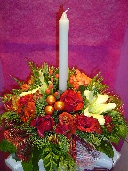 Roses, lillies, carnations, daisies, berries, pine, and Christmas decoration