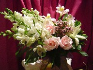 Roses, lillies, alstroemeria, snapdragon, and waxflowers