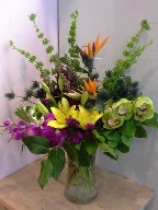 Bells of Ireland, bird of paradise, dendrobium orchids, cymbidium orchids, thistle, asiatic lillies, and dianthus