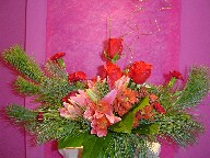 Lillies, daisies, carnations, roses, pine, and Christmas branch