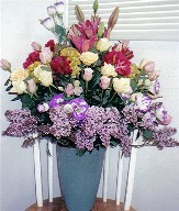 Asiatic lilies, pink and yellow roses, lisianthus, godtheia, lilac and coxcomb