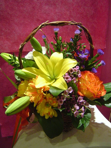 Lilies, monte casino, carnations, waxflowers, daisies, and rose
