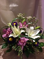 Cymbidium orchids, asiatic lilies, aster, waxflowers, and monkey grass