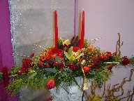 Cymbidium orchids, lillies, gerbera, roses, tulips, coffee beans, pine, pine cones, seed eucalyptus, cedar, and Christmas ornaments